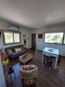 a living room with a couch and a table at Complejo Vista Tres Picos in Sierra de la Ventana