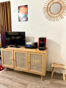 drewniane centrum rozrywki z telewizorem na górze w obiekcie Appartement cosy Centre station de Super Besse pour 2 à 6 personnes w mieście Besse-et-Saint-Anastaise