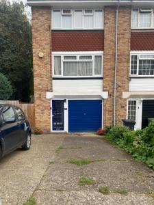 a blue garage door on a brick house at B Homestay in Maidstone