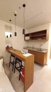 a kitchen with a wooden table and a sink at Salinas Premium Resort in Salinópolis