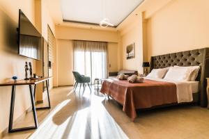 Habitación de hotel con cama y mesa en Nicolas Luxury Suites en Kourouta