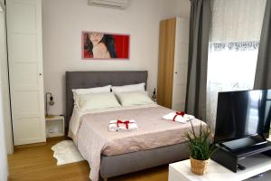 a bedroom with a bed and a television at La Rocca sui Trabocchi in Rocca San Giovanni