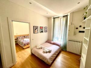 a small room with a bed and a mirror at Fiera-MiCo - Sempione Apartment in Milan
