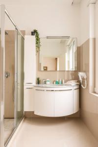 a white bathroom with a shower and a sink at Casa mia Milano Malpensa in Gallarate +57 photos