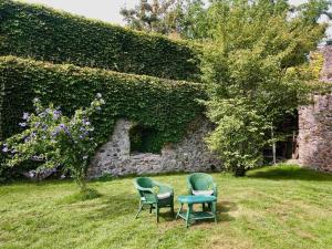 two chairs and a table in front of a stone wall at Urlaub in der Burg am Bodensee in Kressbronn am Bodensee +10 photos