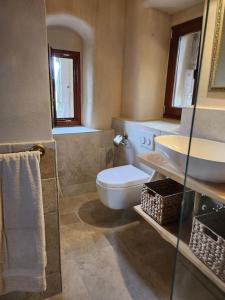 a bathroom with a toilet and a sink at Urlaub in der Burg am Bodensee in Kressbronn am Bodensee