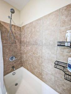 a bathroom with a shower and a bath tub at Luxury & Stylish Townhome, King Beds, W/D, Garage in Schenectady