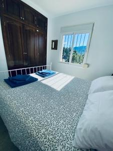 a bedroom with a large bed and a window at Stunning mountain views! Private Villa with fabulous communal pool! in Murla