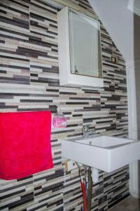 a bathroom with a sink and a red towel at Superbe appartement en plein médina de Tunis in Tunis