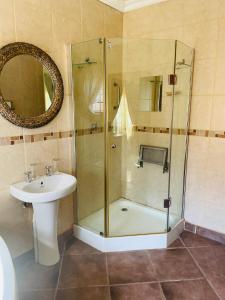 a bathroom with a shower and a sink at Azalea BnB in Kuruman