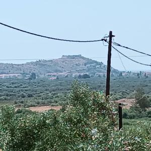 a view of a hill with a telephone pole at Villa Elea in Tseréni