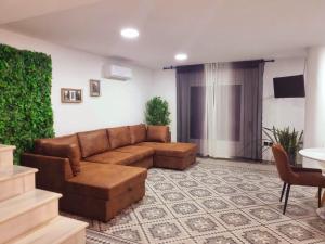 a living room with a brown couch and a table at Luxury apartament airport in Málaga