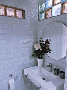 a white bathroom with a sink and a mirror at Luxury apartament airport in Málaga