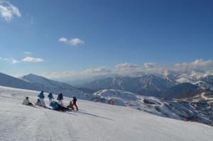 a group of people skiing down a snow covered mountain at Apartaments La Peguera II in Barruera