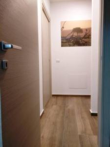 a hallway with a door and a painting on the wall at The Cosy Nest in Pignataro Maggiore