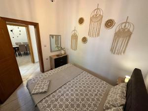 a bedroom with a bed and some decorations on the wall at Casa Magnolia Patras in Patra