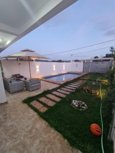 a house with a swimming pool and a yard at Villa de luxe in Imouzzer Kandar