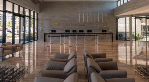 a lobby with couches and a bar in a building at Salinas Premium Resort in Salinópolis