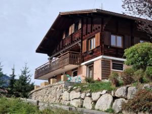 a house on top of a stone wall at Chalet de Manigod in Manigod