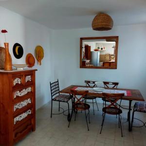 a dining room with a table and chairs and a mirror at Dar Cristina in Houmt Souk +36 photos