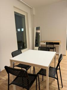 a white table and chairs in a room at Easy Stay Room near Airport in Vantaa