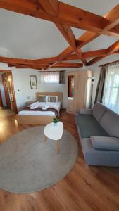 a bedroom with a bed and a couch and a table at Danubia Apartman in Esztergom