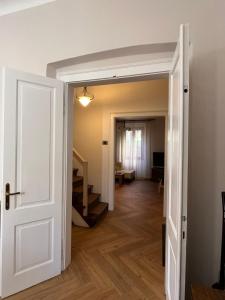 an open door leading to a living room with stairs at Vila Stančič in Portorož