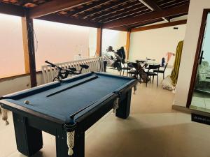 a pool table in the middle of a room at Casa Guaruja in Guarujá