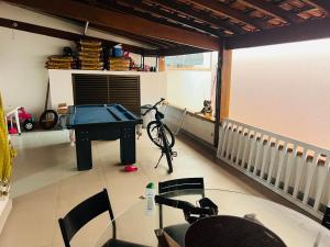 a room with a ping pong table and chairs at Casa Guaruja in Guarujá