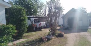 a house with a car parked in a garage at Refugio Amaicha in Embalse