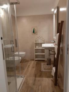 a bathroom with a shower and a sink and a tub at Villa Diletta in Àrbatax