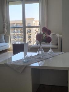 a vase of flowers on a table in a living room at Al rehab city-new cairo in New cairo