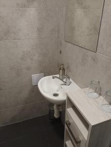 a bathroom with a sink and a mirror at Apartmány u golfu in Jihlava