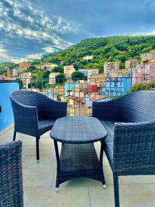 three chairs and a table on a balcony with a view at B&b Niu Susu in Lanusei
