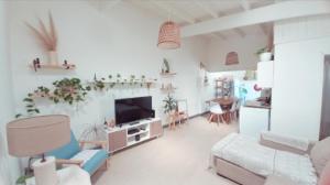 a living room with a couch and a tv at La Puerta Azul in Tandil