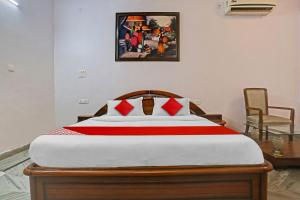 a bedroom with a large bed with red pillows at OYO Flagship Premium rooms in New Delhi