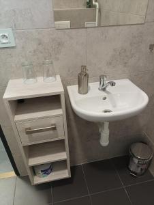 a bathroom with a white sink and a mirror at Apartmány u golfu in Jihlava