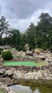 a golf course with a green and some water at Apartmány u golfu in Jihlava