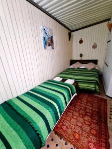 two beds sitting next to each other in a room at Dar Ines in Moulay Idriss Zerhoun