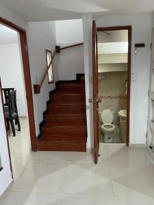 a hallway with a staircase and a toilet in a house at Casa Turistica HL in Armenia