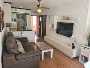 a living room with a couch and a tv at Benidorm in Benidorm