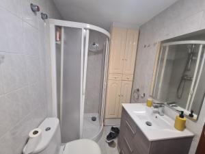 a bathroom with a toilet and a shower and a sink at Benidorm in Benidorm