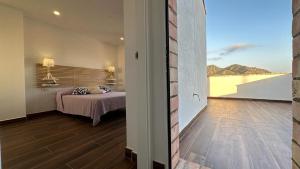 a bedroom with a bed and a view of the ocean at La bocana del Portús in Cartagena