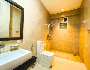 a bathroom with a sink and a toilet and a mirror at Queens Mount Glen Heights in Nuwara Eliya