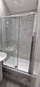 a shower with a glass door in a bathroom at Ilford Town Centre Studio in Ilford