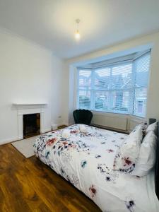 a bedroom with a large bed and a fireplace at Newly refurbished two bedrooms flat in St. Leonards