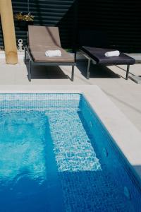 a blue swimming pool with a bench next to it at AMI in Solin