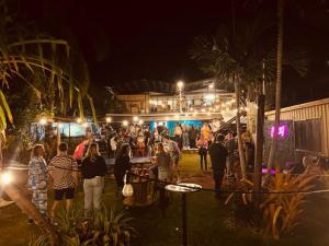 a crowd of people standing outside a food truck at night at Gladstone Backpackers in Gladstone