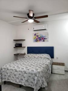 a bedroom with a bed and a ceiling fan at Casa Aura - Center Studio - 1st Floor in Isla Mujeres