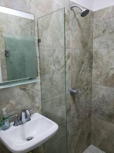 a bathroom with a sink and a shower with a mirror at Casa Aura - Center Studio - 1st Floor in Isla Mujeres